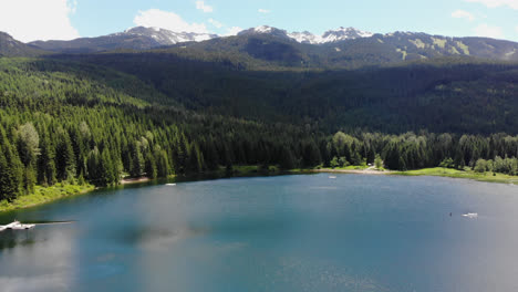 A-drone-aerial-of-a-beautiful-majestic-lake-located-in-Whistler,-British-Columbia