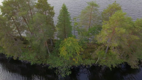Aerial-footage-of-a-narrow-island-in-a-lake-in-Finland