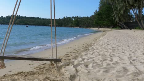 Home-made-swing-on-a-beach-in-a-beautiful-bay-on-an-island-in-Thailand-Cropped