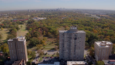 Drone-pulls-away-from-Apartment-buildings-to-reveal-a-historic-neighborhood-district-and-park-urban-park
