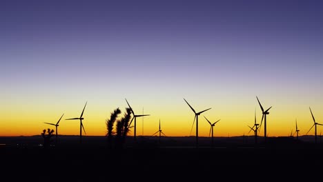Windmills-at-sunrise,-mojave-desert