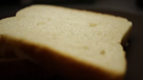 A-pan-around-shot-of-two-pieces-of-white-bread-on-a-plate