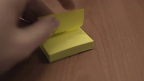 Pulling-a-yellow-post-it-sheet