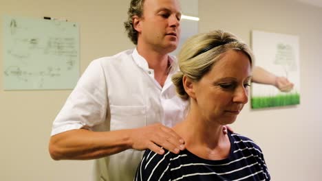Osteopath-is-treating-his-female-patient-in-the-neck-and-upper-back-area