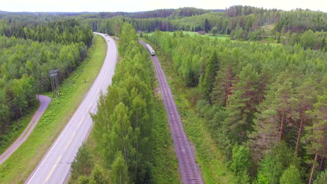 Railroad-and-highway-side-by-side-in-the-middle-of-the-forest