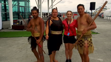 Tourist-getting-a-photo-with-a-group-of-Maori's-from-New-Zealand