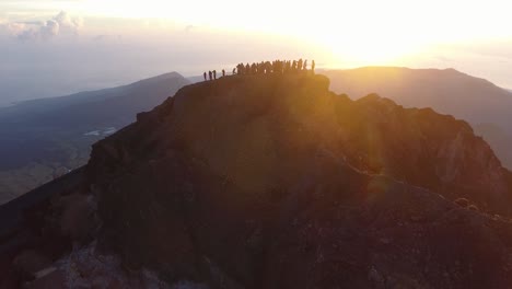 People-on-the-top-of-Mt-Rinjani-during-sunrise,-aerial-shot