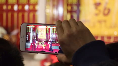 Tourist-Recording-the-Chinese-New-Years-Celebration-in-Hanoi-with-a-Mobile-Phone