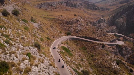 AERIAL:-Following-car-and-motorbike-on-serpentine-road-in-mountains-of-Mallorca