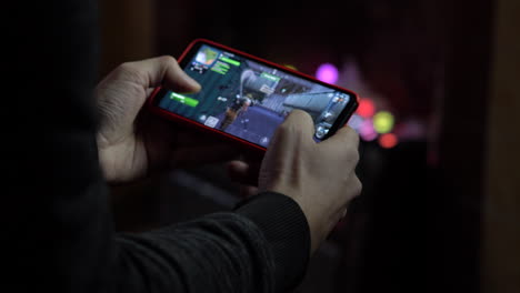2019-Young-Gamer-Playing-Fortnite-on-his-Smartphone