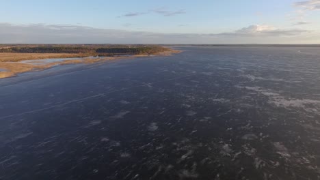 Calm-lake-Burtnieks-with-little-ice-and-high-water-level-in-spring-aerial-view