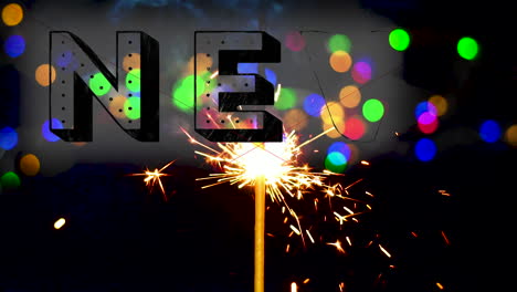 New-Year-Text-overlay-sparklers-giving-off-sparks-and-light-with-colorful-bokeh-background