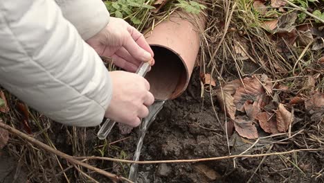 Collecting-drain-pipe-water-sample-with-test-tube
