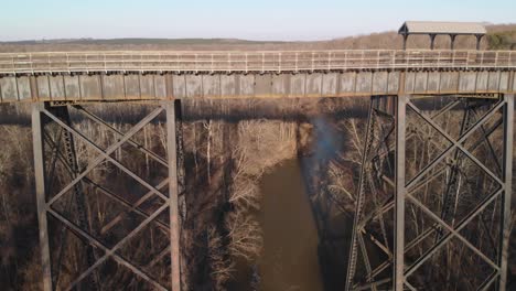 Slowly-descending-to-fly-under-High-Bridge-Trail,-a-reconstructed-Civil-War-railroad-bridge-in-Virginia