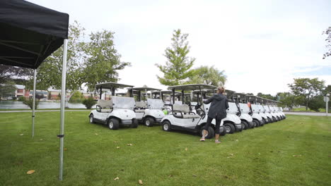 Line-up-of-golf-carts-on-a-golf-course