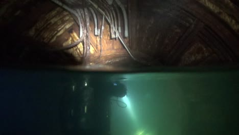 Over-Under-tech-diver-in-flooded-silo-tunnels