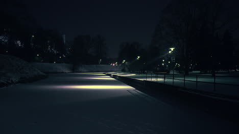 Frozen-pond-covered-with-snow-in-a-city-park-in-Tallinn,-Estonia