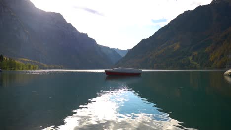 Red-and-white-boat-in-a-beautiful-artificial-lake-in-Switzerland