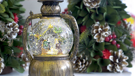Snowglobe-with-child-in-the-manger-on-Christmas-background