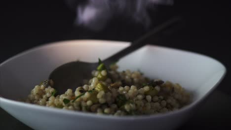 Man-leaving-a-Spoon-on-a-steamy-plate-of-vegetarian-Couscous