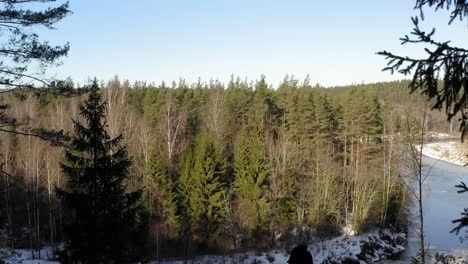Two-tourists-taking-pictures-in-Gauja-National-park-during-winter