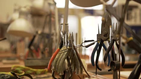 Detail-of-workroom-full-of-pliers,-tweezers,-splitters-and-other-tools-in-slow-motion
