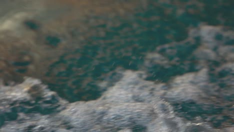 A-closeup-view-of-splashing-water-of-wave-from-the-boat-as-it-moves-through-water