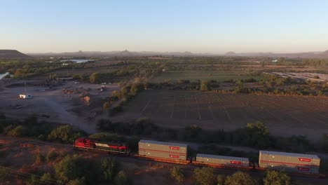 Aerial-shot-of-a-large-cargo-train-in-Sonora-at-Sunset
