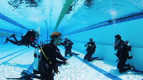 A-group-of-scuba-diving-students-learning-safety-procedures-during-a-scuba-lesson