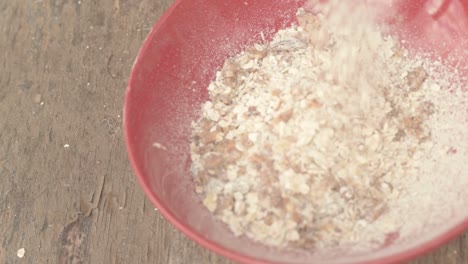 Muesli-pouring-into-a-breakfast-bowl