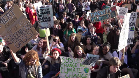 UK-February-2019---Students-chanting-on-a-sit-down-protest-on-a-road-hold-placards-with-messages-about-Climate-Change