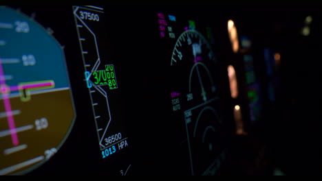 Close-up-of-Electronic-Flight-Instrument-System-EFIS-during-cruise-flight-in-dark-aircraft-cockpit