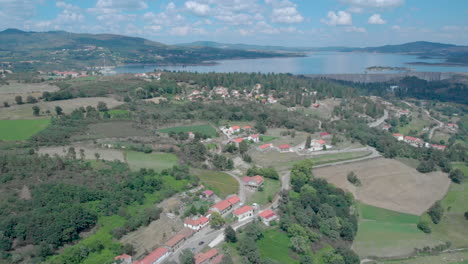Aerial-view-of-Barragem-do-Alto-Rrabagão-and-the-villages-around-in-the-north-of-Portugal,-tilt-reveal