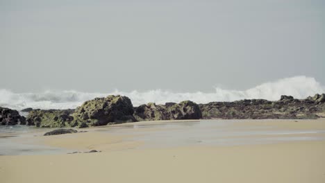 Nature-Sea-Ocean-Shore-Stones-Rocks-Waves-Big-Waves-Waves-Crash-Sand-Seaweed-Wind-Sunny-Daylight-Steady-Shot-4K