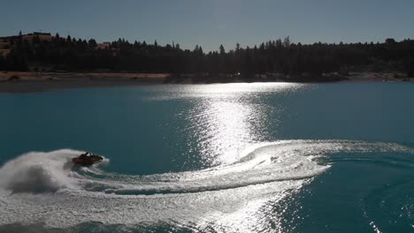 Jet-Ski-on-Beautiful-Turquoise-Blue-Water---Lake-Tekapo,-New-Zealand---Aerial