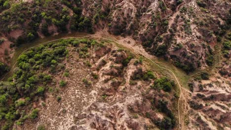 Drone-Shot-Circling-Mountain-Bikers-in-a-Canyon-on-a-Sunny-Day