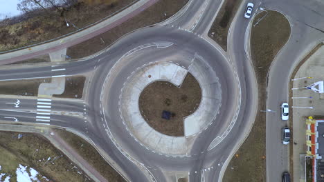 AERIAL:-Slowly-Rising-Above-Roundabout-While-Motor-Vehicles-Enters-and-Exits-It