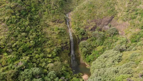 SLOWMO---Aerial-view-of-beatiful-hidden-high-waterfall-Kitekite-Falls-with-lagoon-in-New-Zealand
