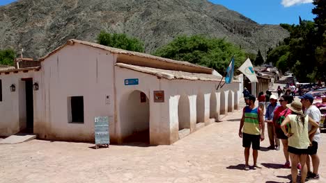 Tourists-at-a-traditional-Cabildo-building-in-Purmamarca,-Argentina