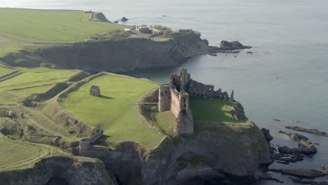 An-aerial-view-of-the-side-of-Tantallon-Castle-ruin-on-a-sunny-day,-East-Lothian,-Scotland