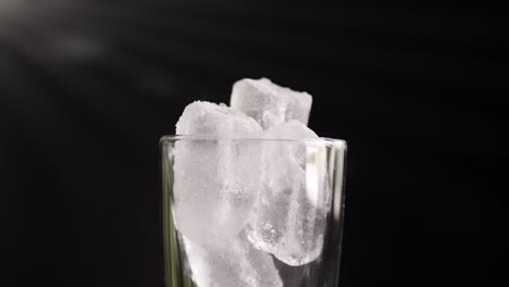 A-showcase-of-the-rotation-ice-in-glass-close-up-of-cold-with-slow-motion-rotating