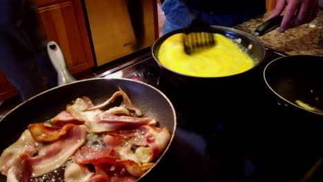 A-fun-time-lapse-taking-from-a-perspective-of-the-stove-front-of-a-guy-cooking-bacon-and-scrambling-eggs