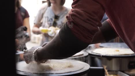 SLOW-MOTION:-Fresh-french-crepes-with-cheese-in-the-making,-Paris