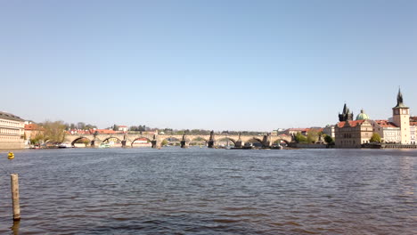 Panning-Shot-of-Charles-Bridge,-Prague-on-Sunny-Spring-Day-in-Slow-Motion