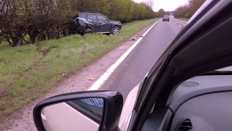 Driving-past-a-car-crash-with-car-skidded-off-road
