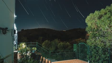 Moon-and-star-trails-from-a-balcony-at-night