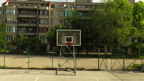 Forward-Aerial-Footage-of-Empty-Basketball-Field-in-the-Neighborhood