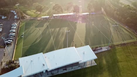 Falling-aerial-drone-footage-into-the-sun-of-Elgar-Park-field-hockey-ground