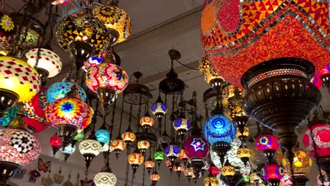 Colorful-and-bright-Turkish-ceiling-lamps-and-chandeliers-hanging-from-the-ceiling-of-a-Turkish-Fine-Arts-Gallery-and-store-in-Carmel-by-the-Sea,-a-popular-tourist-destination-and-arts-town