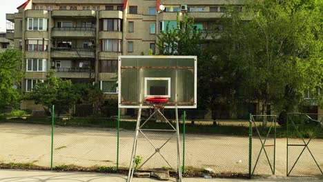 Backward-Aerial-Footage-of-Empty-Basketball-Field-in-the-Neighborhood